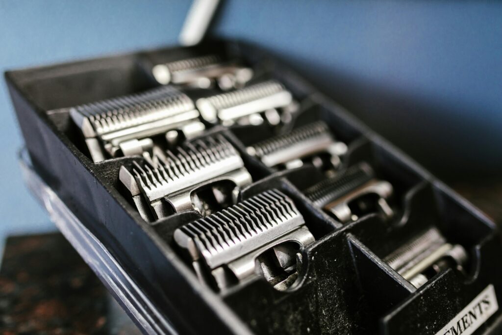 Close-up view of professional barber trimmer attachments neatly arranged in a black box.